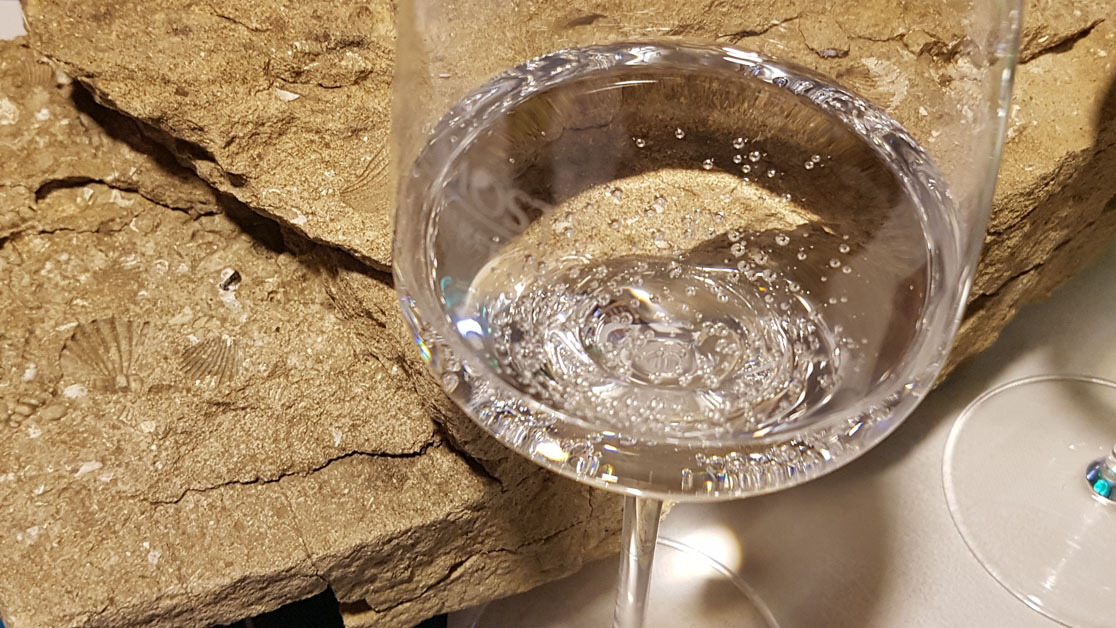 Mineralwasserverkostung mit Gestein im Hintergrund